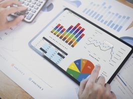 Donna d'affari che utilizza un tablet per analizzare il concetto di successo delle statistiche della strategia finanziaria aziendale e la pianificazione per il futuro nella stanza dell'ufficio